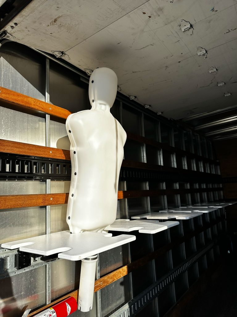 A plastic mannequin mounted in a custom trailer